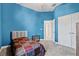 Cozy bedroom with blue walls, carpet flooring, and a double door closet at 14607 Swiss Bridge Dr, Lithia, FL 33547