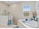 Spa-like bathroom with soaking tub, walk-in shower, and window at 14607 Swiss Bridge Dr, Lithia, FL 33547