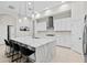 Modern kitchen with white cabinets, large island with waterfall edge, and stainless steel appliances at 14607 Swiss Bridge Dr, Lithia, FL 33547