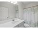 Clean bathroom with a single sink vanity, shower, and white cabinets at 14607 Swiss Bridge Dr, Lithia, FL 33547