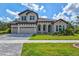 Two-story home with a three-car garage and attractive landscaping at 14607 Swiss Bridge Dr, Lithia, FL 33547