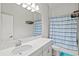 Bathroom with single vanity, shower/tub combo, and polka dot curtain at 14607 Swiss Bridge Dr, Lithia, FL 33547