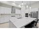 Modern kitchen with white cabinets, stainless steel appliances, and large island at 14607 Swiss Bridge Dr, Lithia, FL 33547
