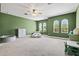 Spacious bedroom with green walls, arch windows, and ample floor space at 14607 Swiss Bridge Dr, Lithia, FL 33547