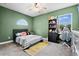 Green-walled bedroom with a bed, built-in shelving, and a workspace at 14607 Swiss Bridge Dr, Lithia, FL 33547