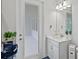 Bathroom with white vanity, a door to an exterior patio, and a large mirror at 14607 Swiss Bridge Dr, Lithia, FL 33547
