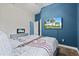 Blue bedroom with queen-size bed and TV at 14607 Swiss Bridge Dr, Lithia, FL 33547