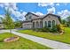 Two-story home with tile roof, three-car garage, and landscaping at 14607 Swiss Bridge Dr, Lithia, FL 33547