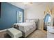 Blue bedroom with queen-size bed and large mirror at 14607 Swiss Bridge Dr, Lithia, FL 33547