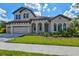 Two-story home with tile roof, three-car garage, and landscaping at 14607 Swiss Bridge Dr, Lithia, FL 33547