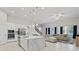 Open concept kitchen with island seating, living area view, and stainless steel appliances at 14607 Swiss Bridge Dr, Lithia, FL 33547