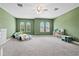 Spacious bedroom with green walls, arch windows, and ample floor space at 14607 Swiss Bridge Dr, Lithia, FL 33547