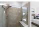 Large walk-in shower with neutral tile and built-in seat at 10646 Spring Tide Way, Parrish, FL 34219