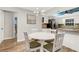 Kitchen features white cabinets, stainless steel appliances, and a breakfast nook at 251 Plantation Rd, Venice, FL 34293