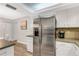 Stainless steel appliances and white cabinetry in this galley kitchen at 251 Plantation Rd, Venice, FL 34293