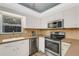 Updated kitchen with stainless steel appliances and ample counter space at 251 Plantation Rd, Venice, FL 34293