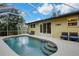 Inviting pool area with screened enclosure, ample seating, and a serene atmosphere at 251 Plantation Rd, Venice, FL 34293