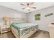 Primary bedroom with ceiling fan and adjacent bathroom at 251 Plantation Rd, Venice, FL 34293