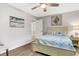 Guest bedroom with coastal-themed bedding and adjacent bathroom at 251 Plantation Rd, Venice, FL 34293