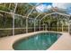 Inviting screened-in pool with lush tropical landscaping at 251 Plantation Rd, Venice, FL 34293