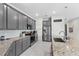 Modern kitchen with gray cabinets, granite countertops and stainless steel appliances at 7434 35Th E Ln, Sarasota, FL 34243