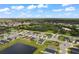 Aerial view of a residential neighborhood with houses and a pond at 7434 35Th E Ln, Sarasota, FL 34243
