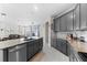 Modern kitchen with gray cabinets, granite countertops, and large island at 7434 35Th E Ln, Sarasota, FL 34243