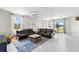 Open concept living room and kitchen with leather sectional at 7434 35Th E Ln, Sarasota, FL 34243