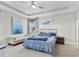 Spacious main bedroom with ceiling fan and large art piece at 7434 35Th E Ln, Sarasota, FL 34243