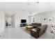 Living room with sectional sofa and view into kitchen at 7434 35Th E Ln, Sarasota, FL 34243