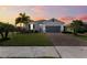 Modern house exterior with gray garage door and paver driveway at 7434 35Th E Ln, Sarasota, FL 34243