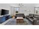 Spacious living room with leather sectional sofa and large TV at 7434 35Th E Ln, Sarasota, FL 34243