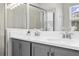 Double vanity bathroom with gray cabinets and quartz countertops at 7434 35Th E Ln, Sarasota, FL 34243