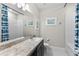 Bathroom with a tub shower combination and dark vanity at 7434 35Th E Ln, Sarasota, FL 34243