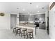 Modern kitchen with gray cabinets, granite countertops, and island with seating at 7434 35Th E Ln, Sarasota, FL 34243