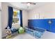 bedroom with a crib and blue accent wall at 7434 35Th E Ln, Sarasota, FL 34243