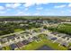 Aerial view of a residential neighborhood with houses and a pond at 7434 35Th E Ln, Sarasota, FL 34243