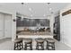Modern kitchen with gray cabinets, granite countertops, and island with seating at 7434 35Th E Ln, Sarasota, FL 34243