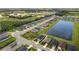 Aerial view of a residential neighborhood with houses and a pond at 7434 35Th E Ln, Sarasota, FL 34243