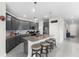 Modern kitchen with gray cabinets, granite countertops, and island with seating at 7434 35Th E Ln, Sarasota, FL 34243
