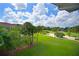 View of lush green golf course from condo at 6503 Stone River Rd # 302, Bradenton, FL 34203