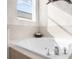 Relax in this spa-like bathroom featuring a luxurious corner jetted tub at 5207 Pine Shadow Ln, North Port, FL 34287