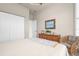 Comfortable bedroom with a dresser and wicker chair at 5207 Pine Shadow Ln, North Port, FL 34287