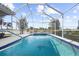 Refreshing pool with a unique tile design in a private screened enclosure at 5207 Pine Shadow Ln, North Port, FL 34287