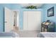 Light blue bedroom with double bed, built-in closet, and a desk at 5207 Pine Shadow Ln, North Port, FL 34287