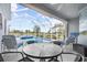 Enjoy the Florida sunshine in this screened pool area with lake views at 5207 Pine Shadow Ln, North Port, FL 34287