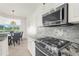 Kitchen detail featuring gas range and microwave at 5207 Pine Shadow Ln, North Port, FL 34287
