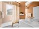 Clean bathroom with a tub, shower, and updated vanity at 5207 Pine Shadow Ln, North Port, FL 34287