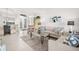Bright living room with tiled floors, comfy seating, and a large window at 5207 Pine Shadow Ln, North Port, FL 34287