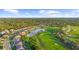 Aerial view of community with lake and golf course at 5207 Pine Shadow Ln, North Port, FL 34287